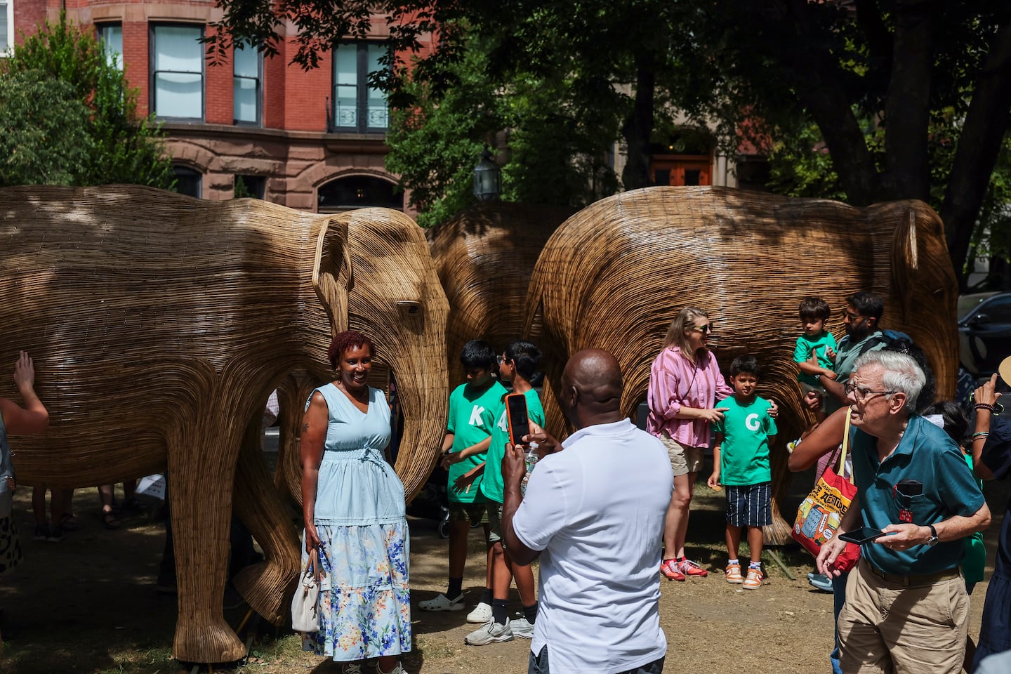 Visitors posed for photos among the elephant sculptures of The Great Elephant Migration along Commonwealth Avenue on July 10.