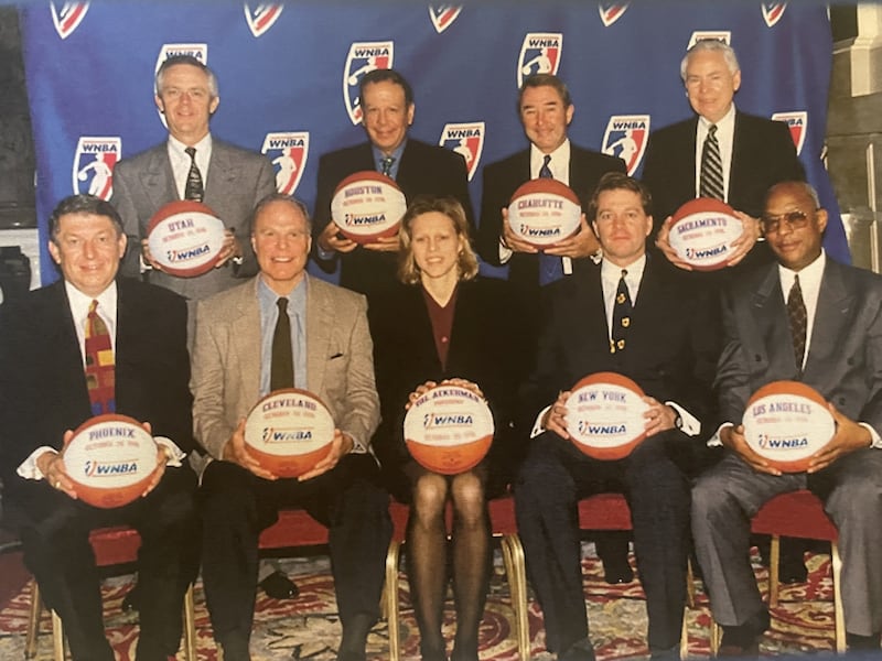 As the first president of the WNBA, Val Ackerman posed with the eight original team owners.