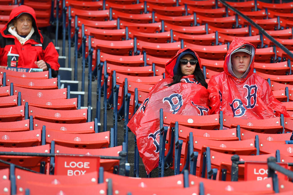 Baseball fans sit in the stands at Fenway Park, in Boston, Saturday, May 9, 2026, following an announcement that a game between the Tampa Bay Rays and the Boston Red Sox scheduled for Saturday was postponed due to rain. (Steven Senne/AP)