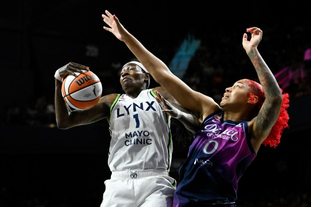 Natasha Howard of the Lynx rebounds the ball against Shakira Austin of the Washington Mystics during Friday's game in Washington, DC. (Photo by Hannah Foslien/Getty Images)