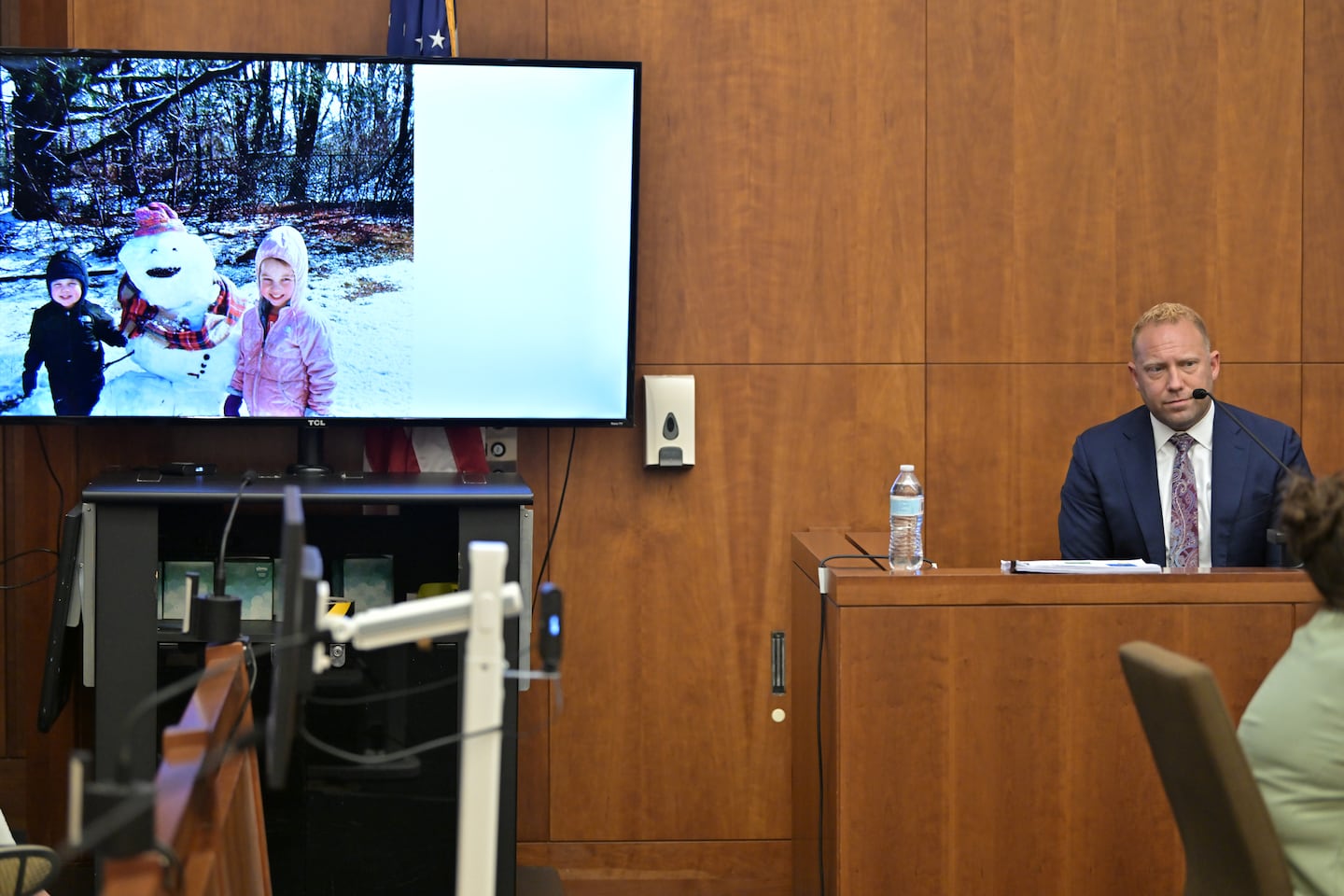 Timothy Chiappini, a cell forensics expert with the Massachusetts State Police, sat on the witness stand during Lindsay Clancy's trial beside a photo of Dawson Clancy and Cora Clancy.