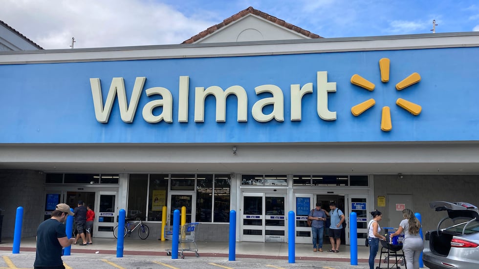 Shoppers enter a Walmart store, Monday, Jan. 2, 2023, in Hallandale Beach, Fla.