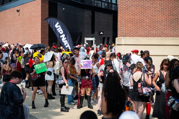 BTS fans gather outside M&T Bank Stadium, filling the sidewalks and forming long lines more than four hours before the start of the concert. (Ryan Bowie/Staff)