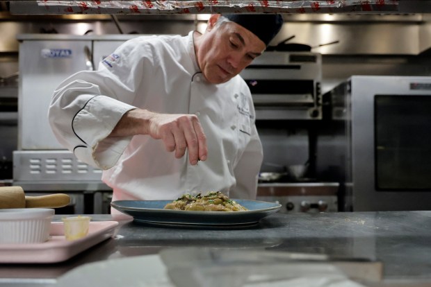 Chef Keith Blauschild prepares a chicken dish for his Rosh Hashana menu at The Cook and the Cork on Thursday, Aug. 20, 2026. (Mike Stocker/South Florida Sun Sentinel)