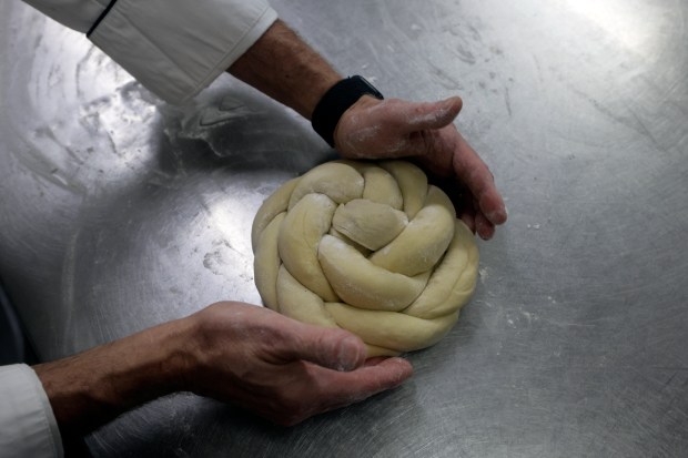 Chef Keith Blauschild prepares a challah for his Rosh Hashana menu at The Cook and the Cork on Thursday, Aug. 20, 2026. (Mike Stocker/South Florida Sun Sentinel)