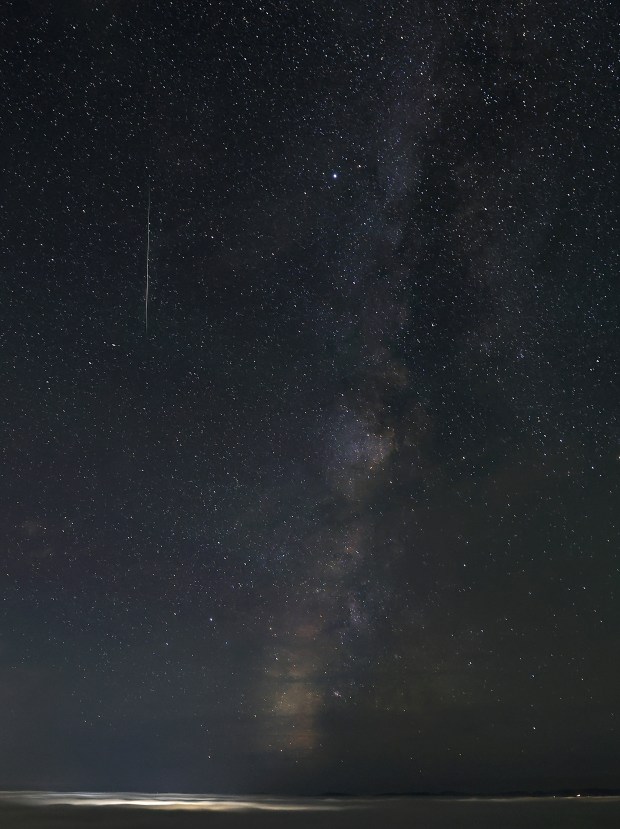 The marine layer fills Alexander Valley as the Milky Way highlights a falling Perseid meteor, Thursday morning, August 13, 2026. The lights of Geyserville illuminate the fog. The Perseids are remnants of comet 109P/Swift-Tuttle, and will be active until Aug. 24. Kent Porter / The Press Democrat)