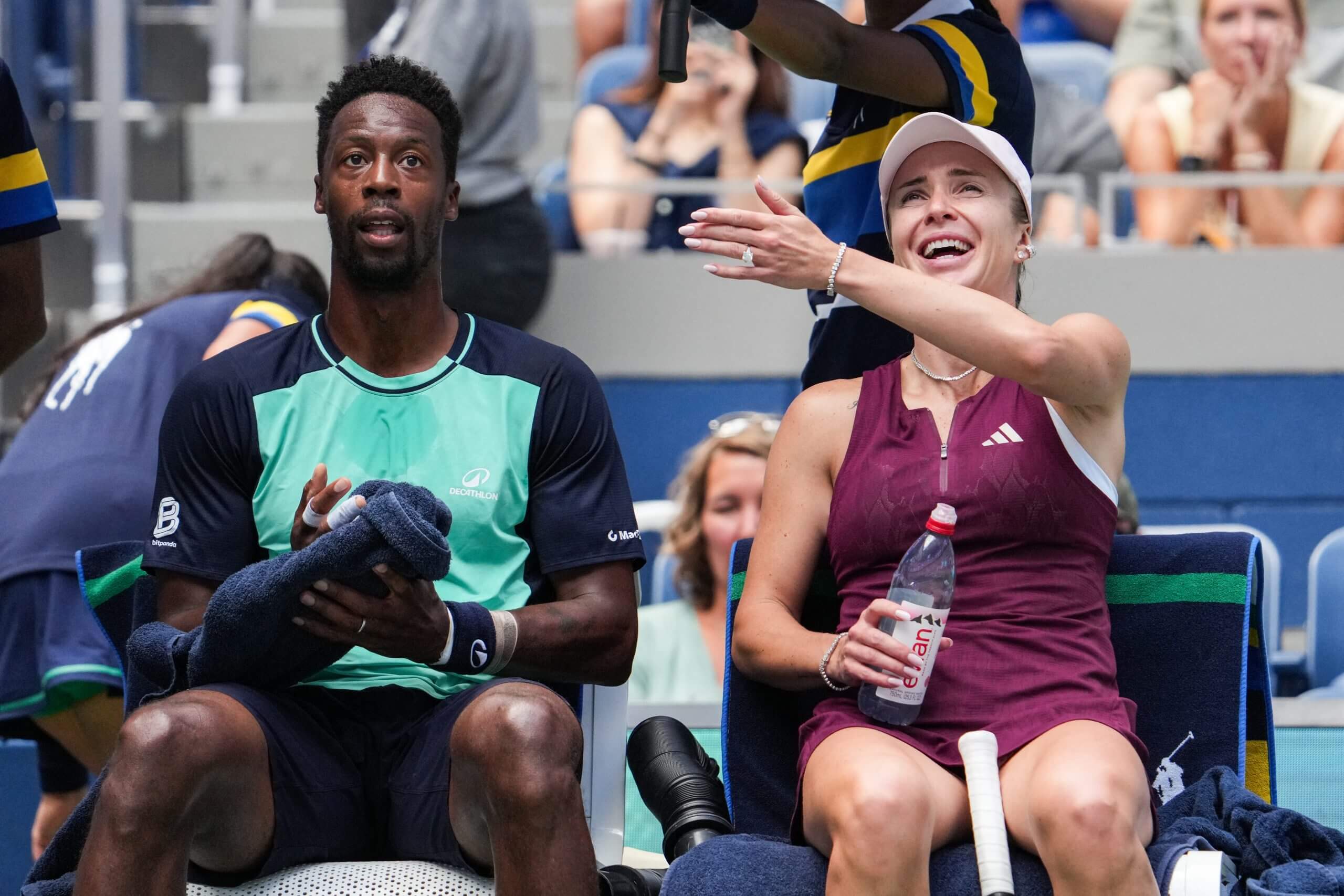 Gaël Monfils and Elina Svitolina sit side-by-side, Svitolina smiling and gesturing toward Monfils.