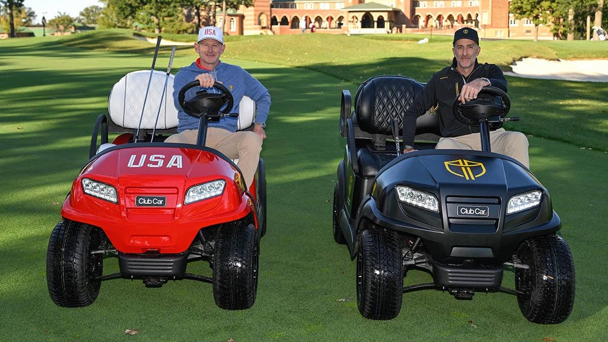 Brandt Snedeker and Geoff Ogilvy sit in golf carts during Captains Day