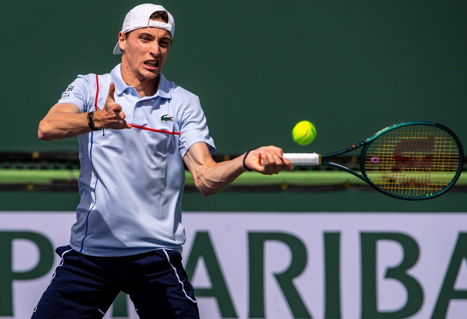 Ugo Humbert hits a forehand during a doubles match at Indian Wells.