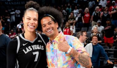 Alysha Clark (left) and librarian Mychal Threets (right) take a photo before one of the Las Vegas Aces' home games in 2024.