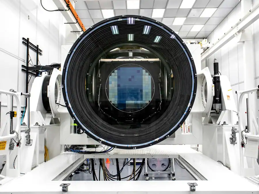 View directly into the huge camera of the Vera Rubin Observatory against white industrial background