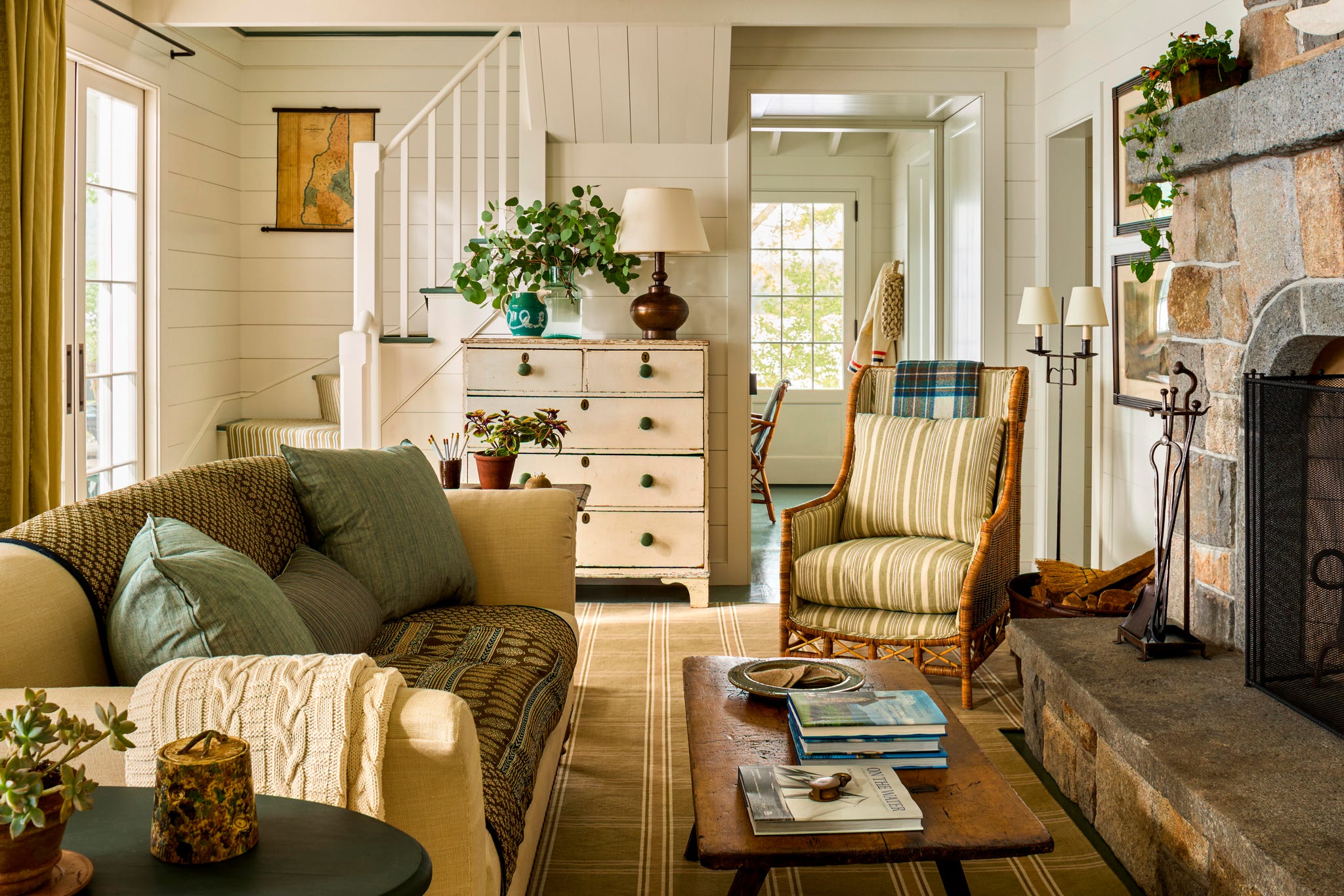 Cozy living room with natural light, comfortable seating, and decorative plants. Cozy living room with natural light, comfortable seating, and decorative plants.