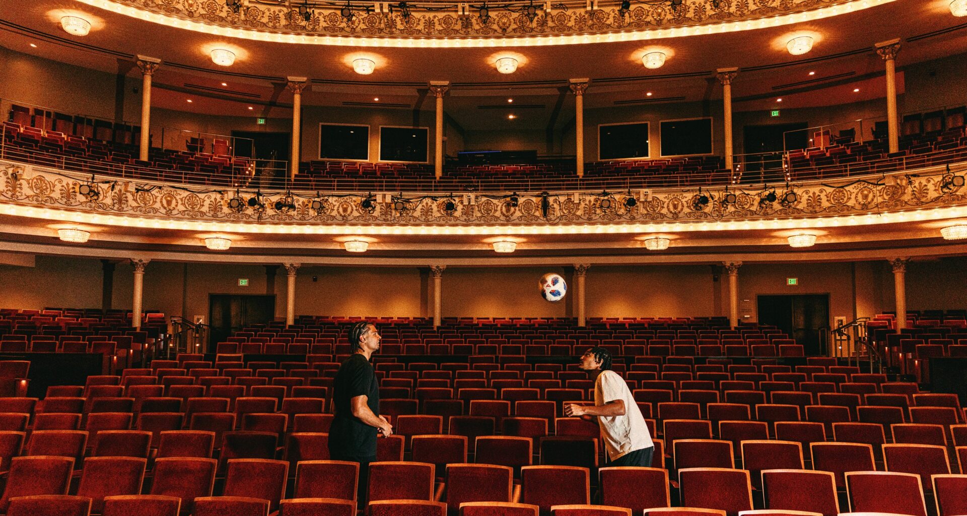 FC Cincinnati defender Miles Robinson (from left) and forward Kenji Mboma Dem practice heading a soccer ball among theater seats inside Music Hall in Cincinnati.