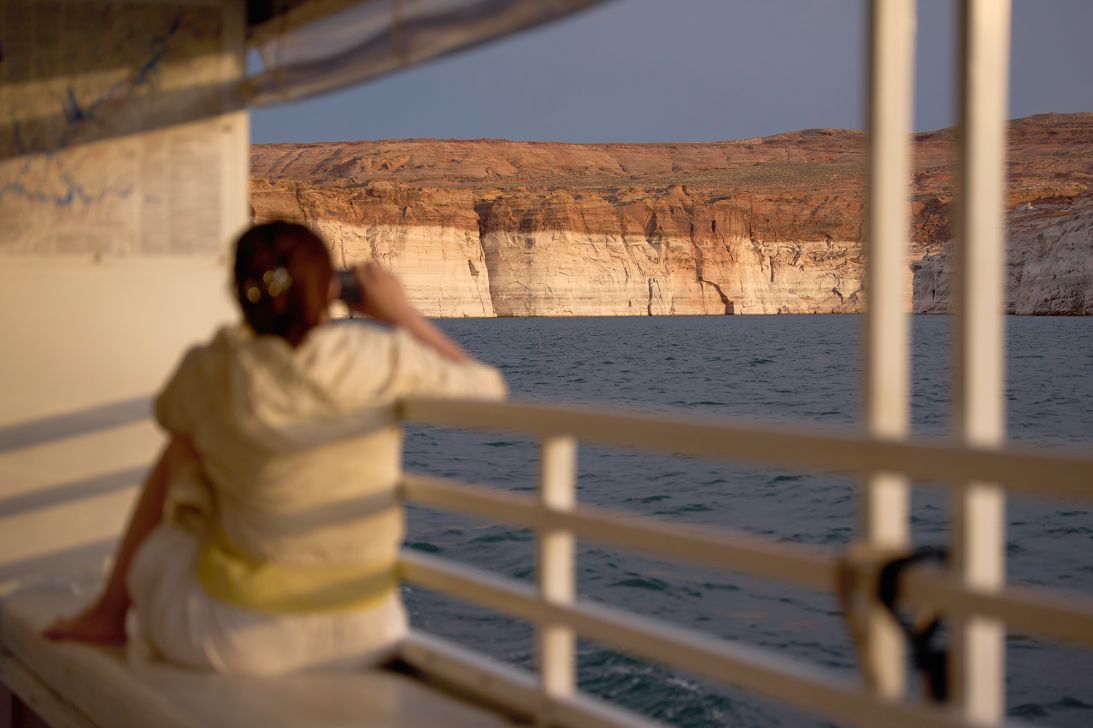 A bathtub ring on the canyon wall shows the high water mark of the reservoir as a person takes a picture during a tour on Lake Powell on July 15.