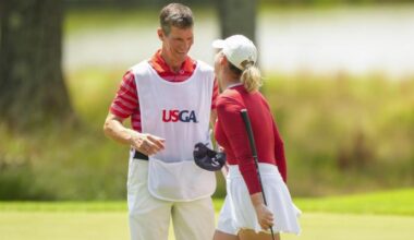Rachel Heck celebrates her 1 up win in the Round of 64 on Thursday with her father, Robert, who serves as her caddie.