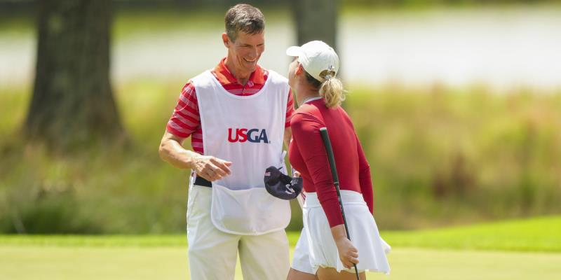 Rachel Heck celebrates her 1 up win in the Round of 64 on Thursday with her father, Robert, who serves as her caddie.