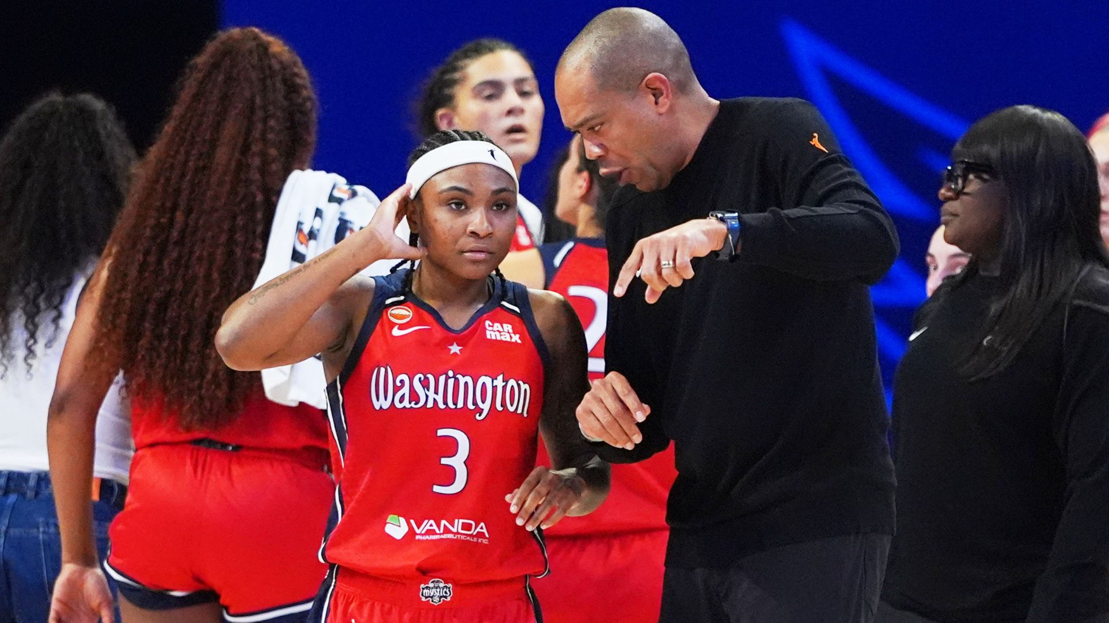 Washington Mystics guard Rori Harmon (3) listens to head coach Sydney Johnson during the first half of a May 18 WNBA basketball game against the Dallas Wings.