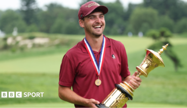 Jack Whaley holding the US Amateur golf trophy