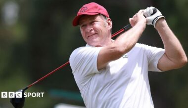 Sir Nick Faldo watches the ball down the fairway having driven from the tee