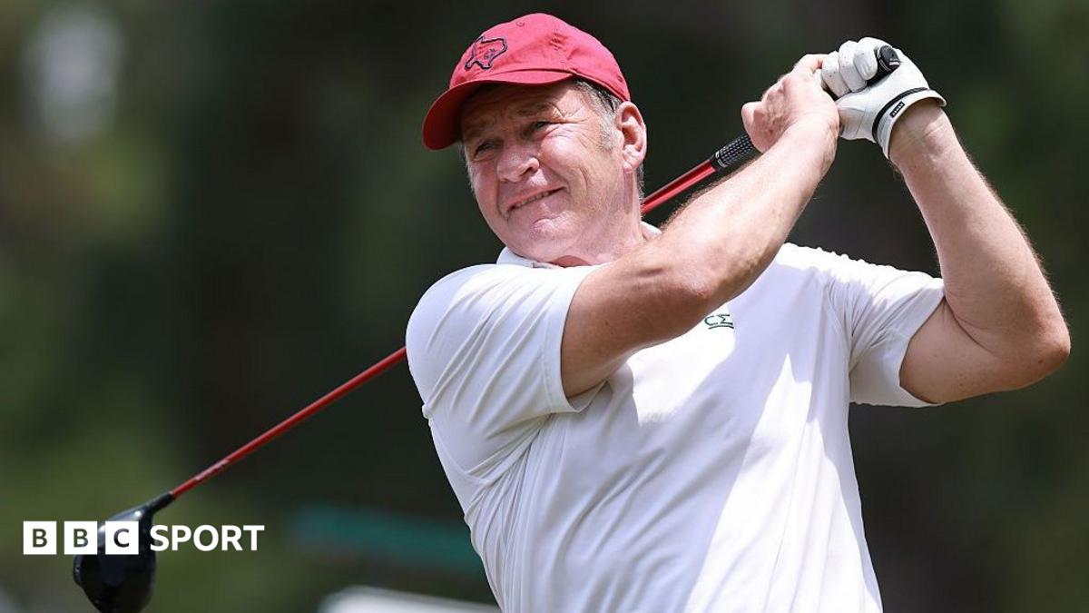 Sir Nick Faldo watches the ball down the fairway having driven from the tee
