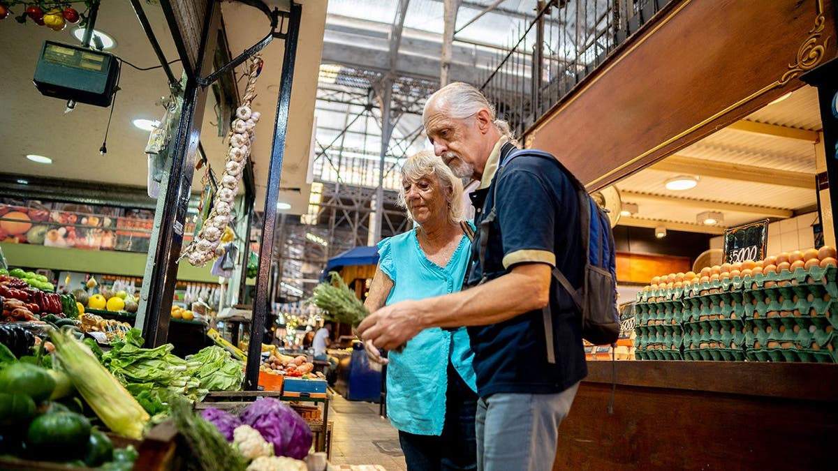 A pair of baby boomers shops in a grocery store.