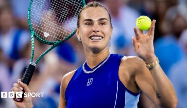 Aryna Sabalenka holds up a ball and her tennis racquet after beating Wang Xinyu at the Cincinnati Open