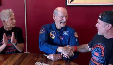 Space Shuttle astronaut adds signature to dollar bill in Florida