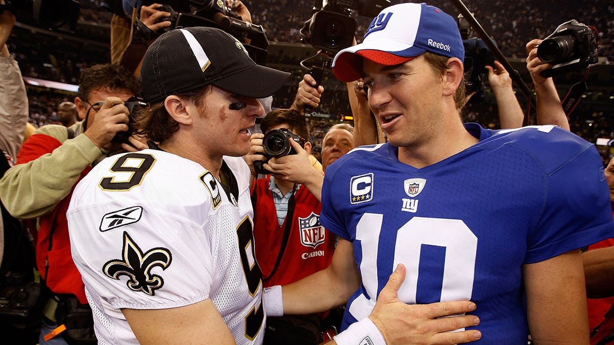Drew Brees is congratulated by Eli Manning after a Saints game in New Orleans.
