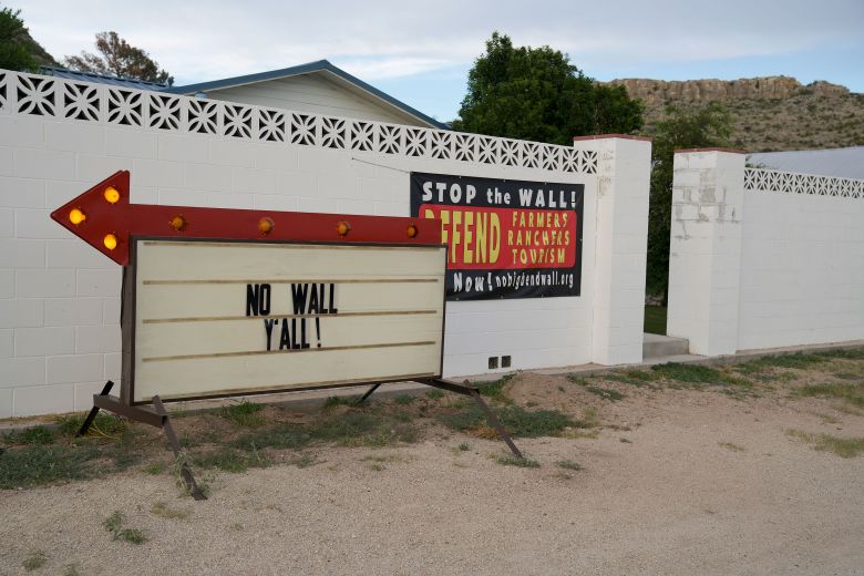 Signs in Sanderson, Texas reflect local pushback against the Trump administration’s plan to construct miles and miles of vehicle barriers along the border in Terrell County.