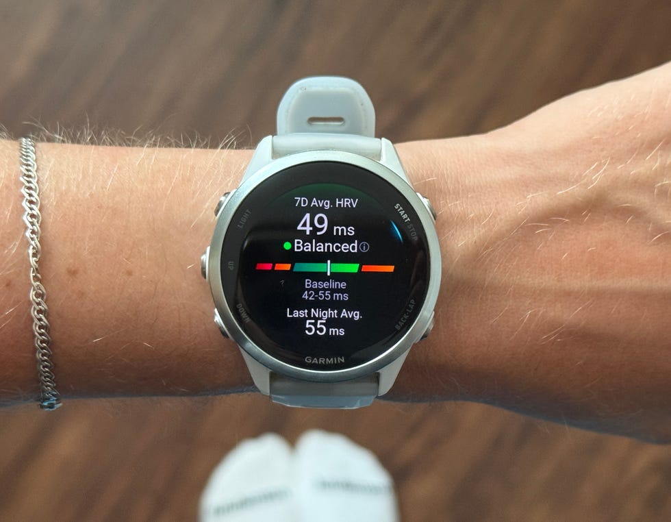 Garmin watch displaying heart rate variability metrics: 49 ms with balanced status, last night average is 55 ms. Garmin watch displaying heart rate variability metrics: 49 ms with balanced status, last night average is 55 ms.