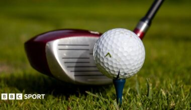Picture showing golf driver next to a golf ball on a tee