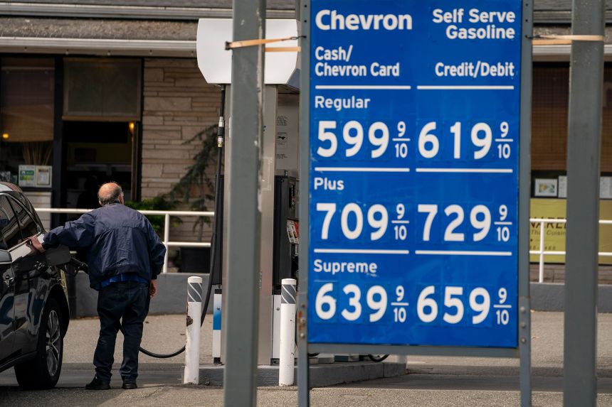 A driver refuels a vehicle with regular gasoline at a Chevron gas station in Seattle, Washington, on April 30, 2026.