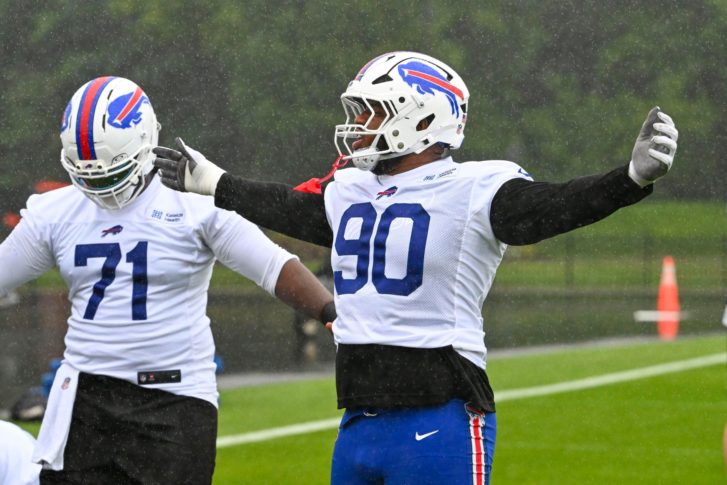 ROCHESTER, NEW YORK - JULY 29: DeWayne Carter #90 of the Buffalo Bills embraces the rain during a break in drills during training camp at St. John Fisher University on July 29, 2026 in Rochester, New York. (Photo by Joe Hrycych/Getty Images)