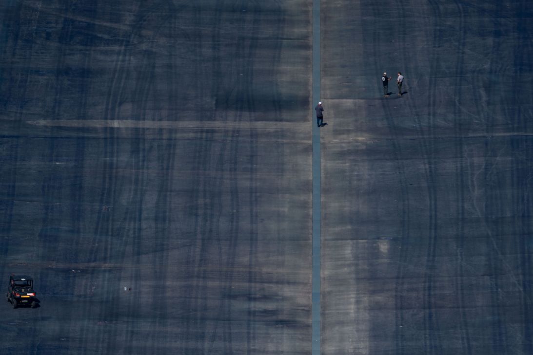 People are seen walking on the basin floor of the Lincoln Memorial Reflecting Pool on the National Mall in Washington, DC, on July 30.