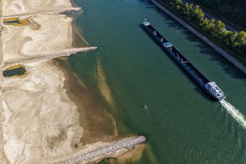 A bulk carrying cargo vessel navigates a channel on the River Rhine past the exposed riverbed caused by low water levels in Kaub, Germany, on Monday.