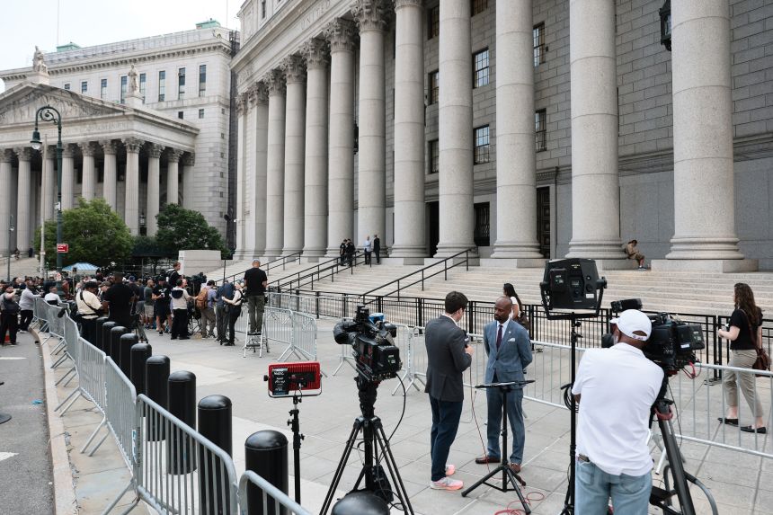 Reporters gather outside the courthouse ahead of Luigi Mangione's hearing Friday in New York.