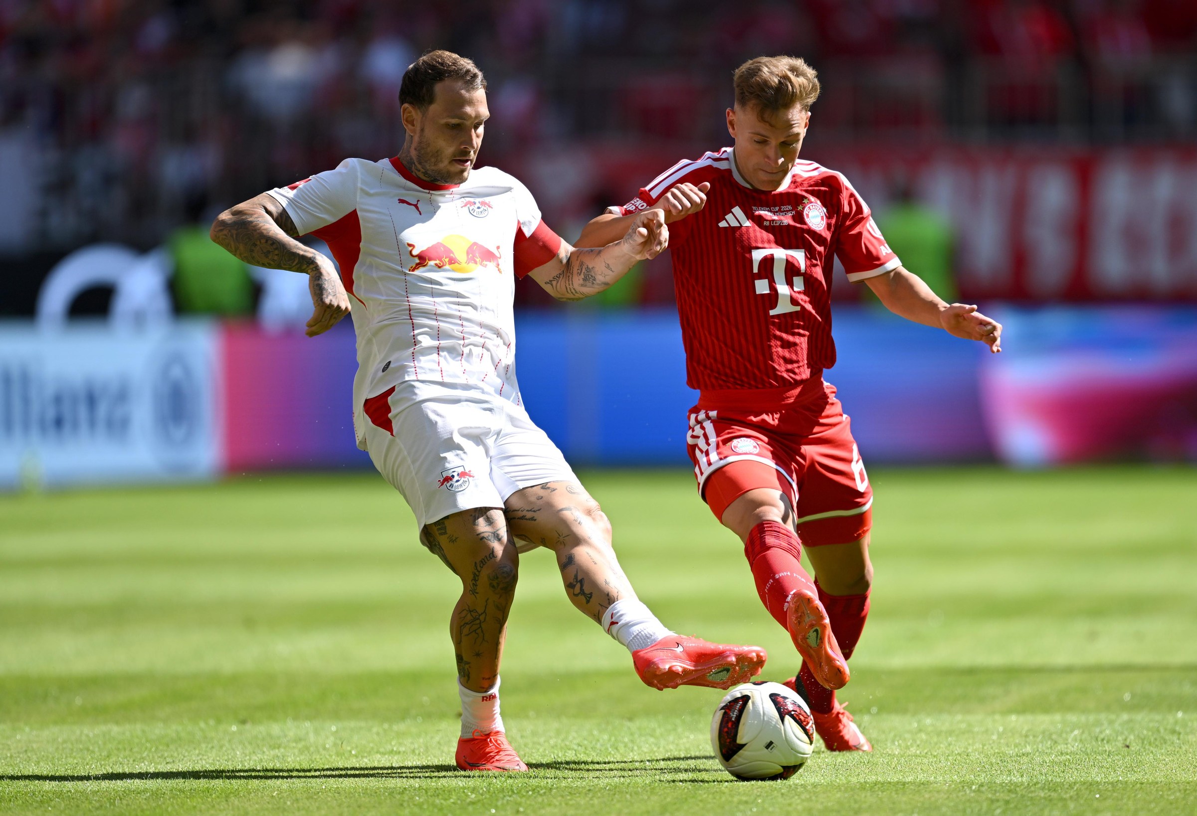 MUNICH, GERMANY - AUGUST 15: David Raum of RB Leipzig and Joshua Kimmich of Bayern Munich battle for possession during the Telekom Cup match between FC Bayern München and RB Leipzig at Allianz Arena on August 15, 2026 in Munich, Germany. (Photo by Christian Kaspar-Bartke/Getty Images)