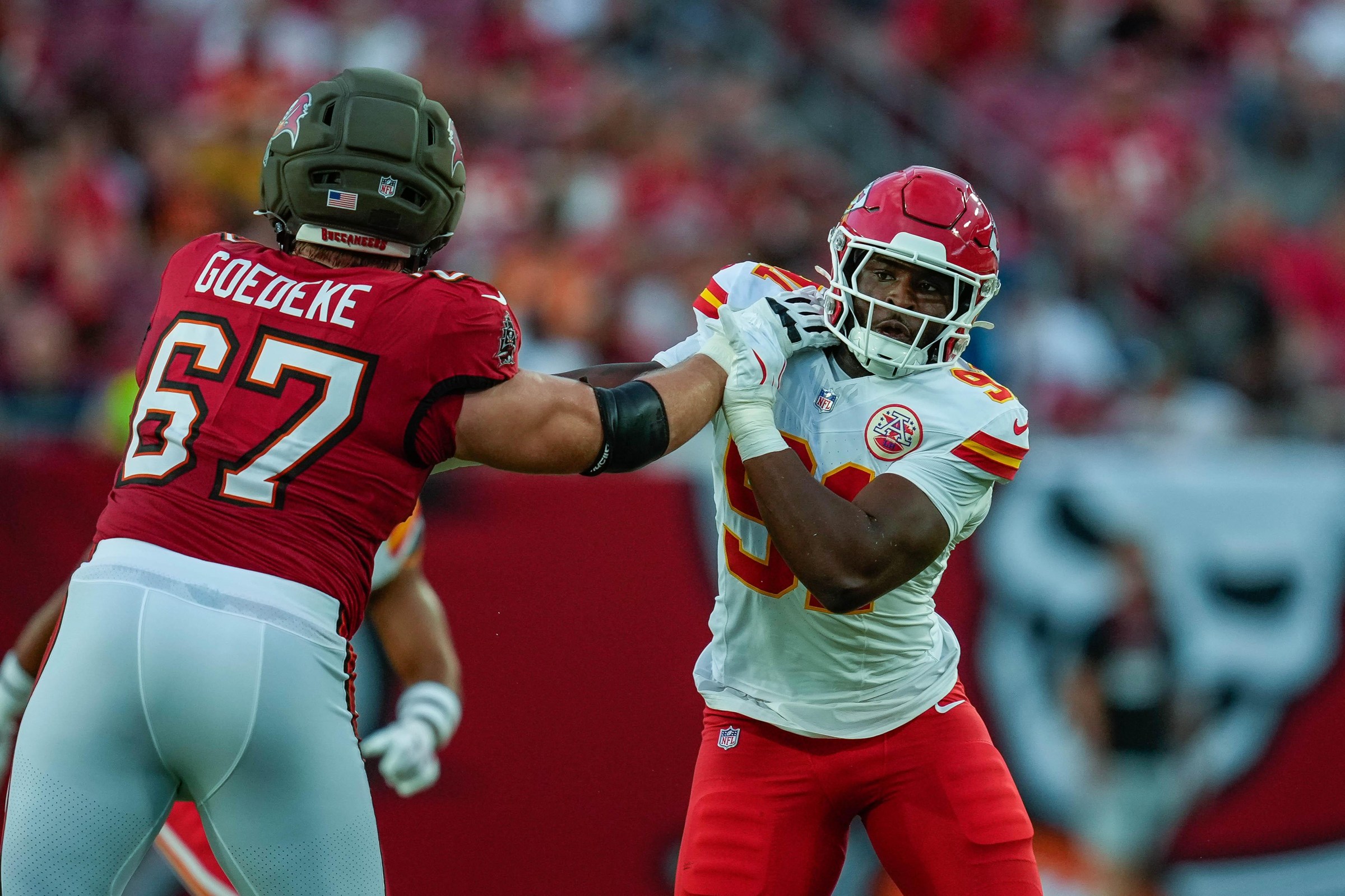 TAMPA, FL - AUGUST 22: Kansas City Chiefs defensive end Felix Anudike-Uzomah (91) attempts to elude the outstretched arm of Tampa Bay Buccaneers offensive tackle Luke Goedeke (67) during a game between the Kansas City Chiefs and the Tampa Bay Buccaneers, Saturday, August 22, 2026 at Raymond James Stadium in Tampa, Florida. (Photo by Ricky Bowden/Icon Sportswire via Getty Images)