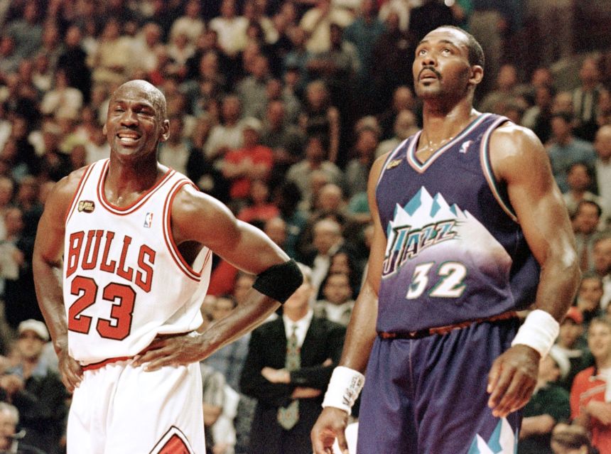 Michael Jordan, left, of the Chicago Bulls smiles while standing next to Karl Malone of the Utah Jazz.