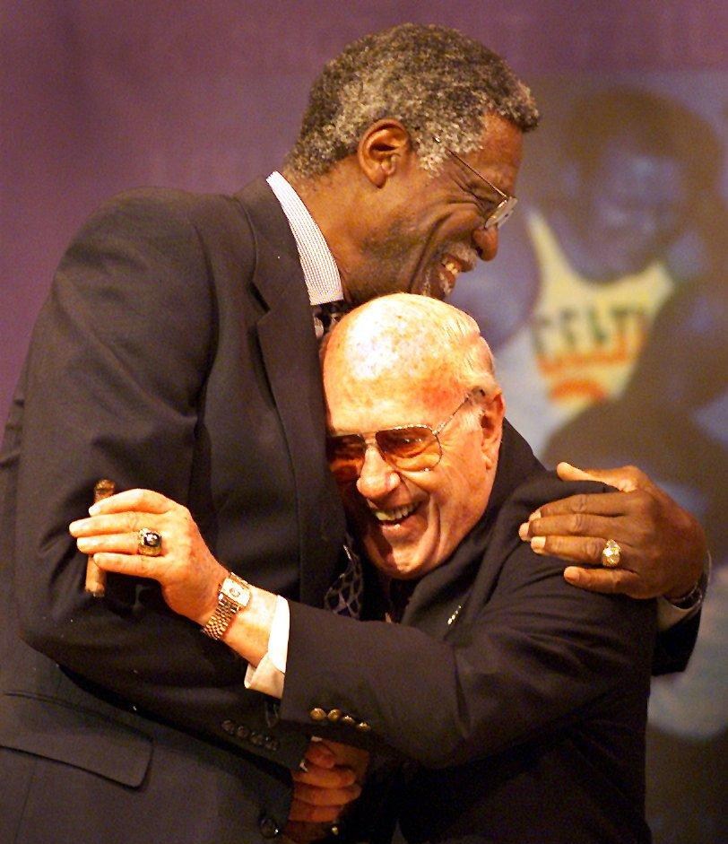 Bill Russell, left, and Red Auerbach hug as Russell is introduced and during his tribute in Boston in 1999. Russell and Auerbach forged the most successful coach/player partnership in NBA history. (Photo by Jim Davis/The Boston Globe via Getty Images)