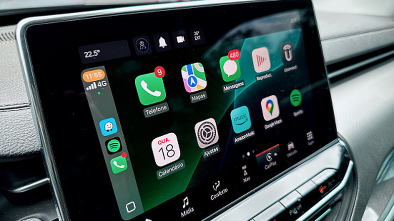 A close-up view of a car display with an active Apple CarPlay connection, with a list of apps visible.