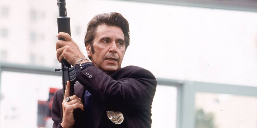 Al Pacino wearing a badge and wielding a gun as Vincent in Heat