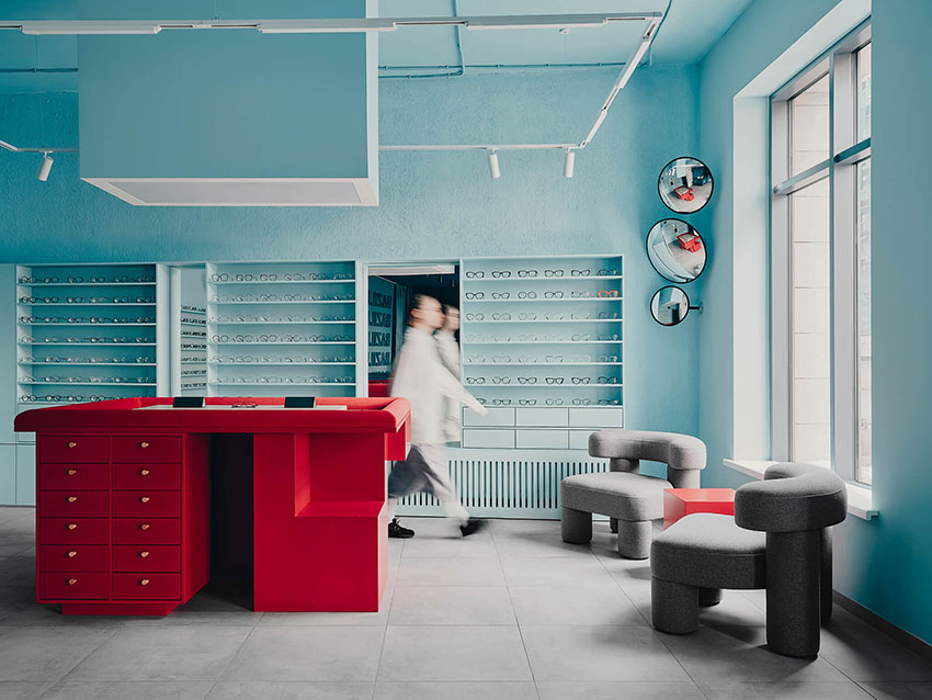 hubarch wraps an optics boutique in cold blue with single red interruption 1