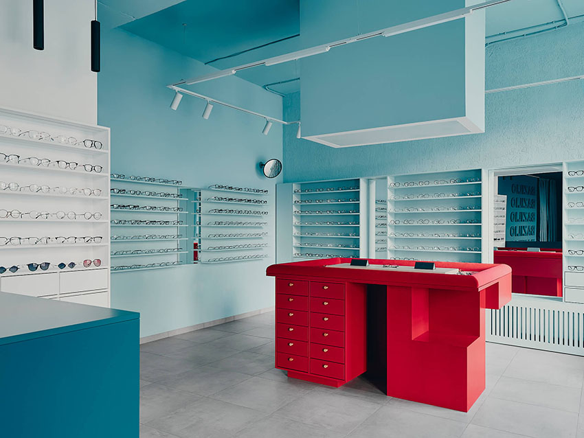hubarch wraps an optics boutique in cold blue with single red interruption 3