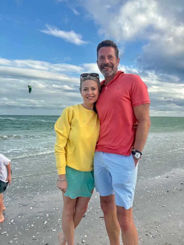 Kristopher Karolkiewicz and Amanda Karolkiewicz standing on a beach.