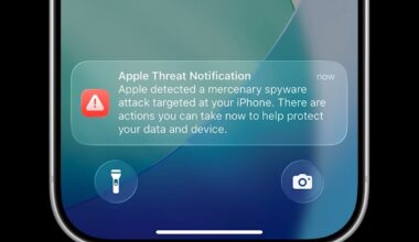 an Apple threat notification on an iPhone lock screen.