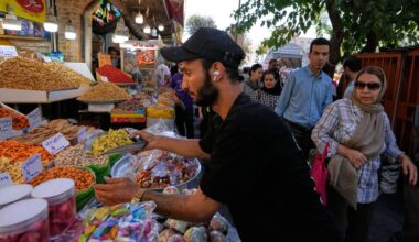 A shopkeeper arranges snacks at his shop at Tehran's Grand Bazaar in Tehran, Iran, Tuesday, Aug. 25, 2026. (AP Photo/Vahid Salemi)