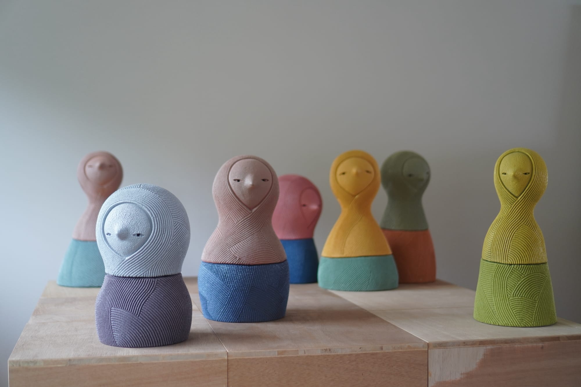 a collection of abstract ceramic sculptures by en iwamura with a tiny face