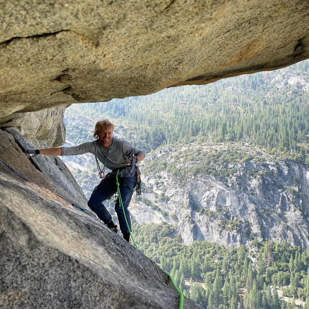 Jake Whisenant smiling while rock climbing in Yosemite.
