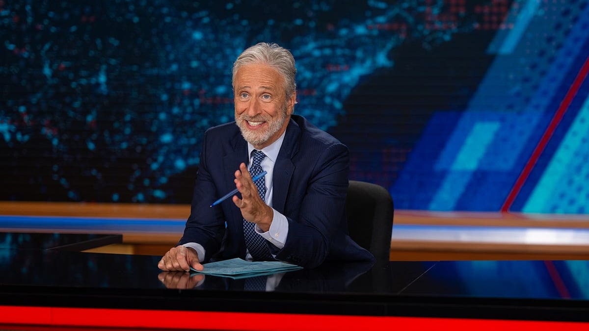 Jon Stewart standing on the set of The Daily Show in New York